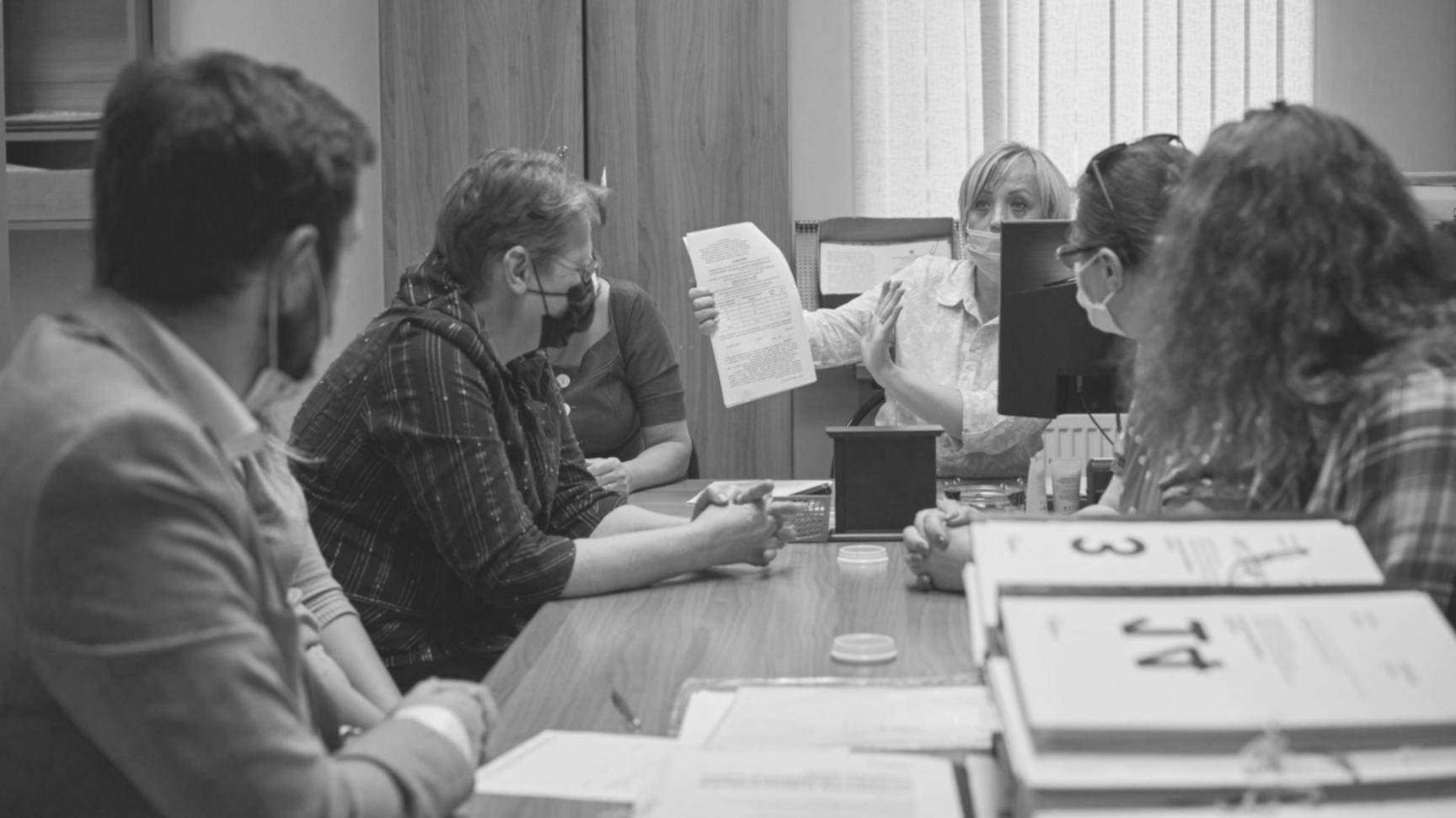 Comprehensive UAT coordination meeting with business stakeholders reviewing software testing results and implementation timeline